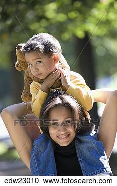 Stock Photography - hispanic mother 
carrying son on 
shoulders. fotosearch 
- search stock 
photos, pictures, 
images, and photo 
clipart