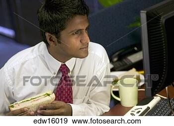 Stock Photograph - indian businessman 
eating lunch at 
desk. fotosearch 
- search stock 
photos, pictures, 
images, and photo 
clipart