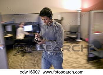 Picture - indian businessman 
using electronic 
organizer and 
headset. fotosearch 
- search stock 
photos, pictures, 
images, and photo 
clipart
