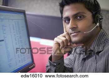 Stock Photography - indian businessman 
using headset 
while working. 
fotosearch - search 
stock photos, 
pictures, images, 
and photo clipart