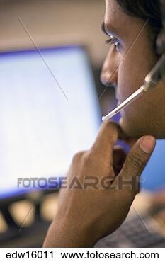 Stock Photography - indian businessman 
using headset 
while working. 
fotosearch - search 
stock photos, 
pictures, images, 
and photo clipart