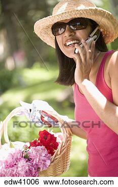 Stock Photo - indian woman gardening 
and using cell 
phone. fotosearch 
- search stock 
photos, pictures, 
images, and photo 
clipart