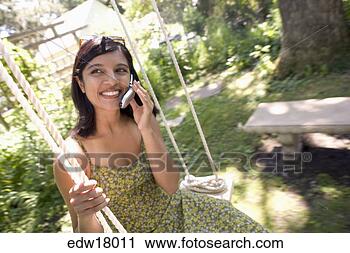 Stock Photography - indian woman talking 
on cell phone. 
fotosearch - search 
stock photos, 
pictures, images, 
and photo clipart