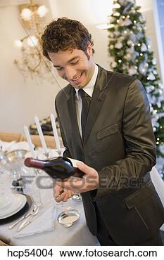 Stock Photo - man examining 
bottle of wine. 
fotosearch - search 
stock photos, 
pictures, images, 
and photo clipart