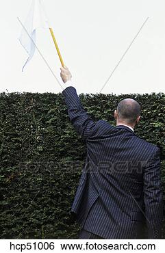 Stock Photo - man in hedge maze 
surrendering with 
white flag. fotosearch 
- search stock 
photos, pictures, 
images, and photo 
clipart