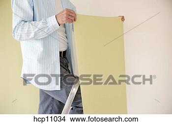 Stock Photo - man putting up 
wallpaper. fotosearch 
- search stock 
photos, pictures, 
images, and photo 
clipart