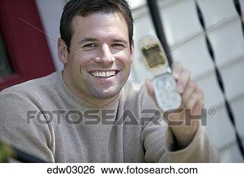 Stock Photo - man showing off 
cell phone. fotosearch 
- search stock 
photos, pictures, 
images, and photo 
clipart
