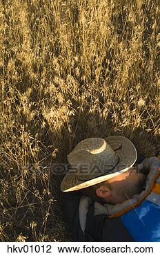 Stock Photo - man sleeping with 
straw hat over 
eyes. fotosearch 
- search stock 
photos, pictures, 
images, and photo 
clipart