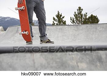 Picture - man standing on 
skate ramp. fotosearch 
- search stock 
photos, pictures, 
images, and photo 
clipart