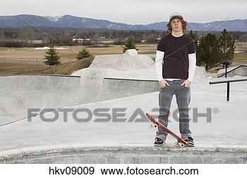 Stock Photograph - man standing on 
skate ramp. fotosearch 
- search stock 
photos, pictures, 
images, and photo 
clipart