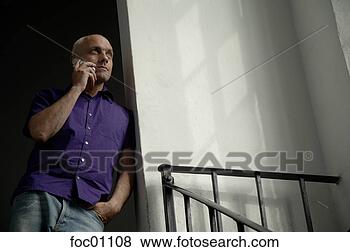 Stock Photo - man talking on 
cell phone in 
stairwell. fotosearch 
- search stock 
photos, pictures, 
images, and photo 
clipart
