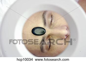 Stock Photo - man with therapeutic 
hot stone on forehead. 
fotosearch - search 
stock photos, 
pictures, images, 
and photo clipart