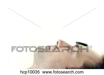 Stock Image - man with therapeutic 
hot stone on forehead. 
fotosearch - search 
stock photos, 
pictures, images, 
and photo clipart