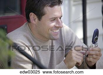 Stock Image - man using cell 
phone. fotosearch 
- search stock 
photos, pictures, 
images, and photo 
clipart