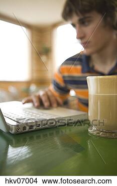 Stock Photo - man using laptop 
in cafe. fotosearch 
- search stock 
photos, pictures, 
images, and photo 
clipart