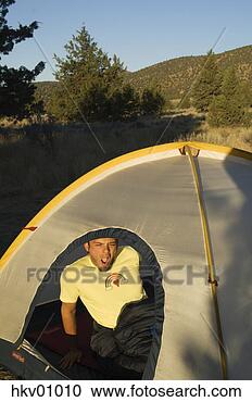 Stock Photography - man waking up 
in tent. fotosearch 
- search stock 
photos, pictures, 
images, and photo 
clipart