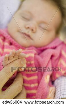 Stock Photo - newborn holding 
adult finger. 
fotosearch - search 
stock photos, 
pictures, images, 
and photo clipart