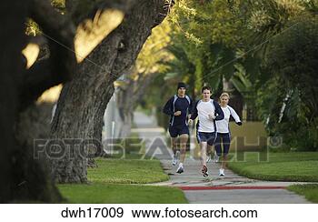 Stock Photograph - people jogging 
on suburb sidewalk. 
fotosearch - search 
stock photos, 
pictures, images, 
and photo clipart