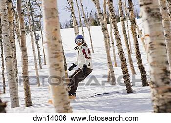 Stock Photo - person snowboarding 
in woods. fotosearch 
- search stock 
photos, pictures, 
images, and photo 
clipart