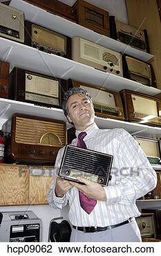 Stock Photo - salesman holding 
radio. fotosearch 
- search stock 
photos, pictures, 
images, and photo 
clipart