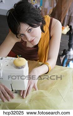 Stock Image - seamstress using 
sewing machine. 
fotosearch - search 
stock photos, 
pictures, images, 
and photo clipart