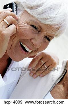 Stock Photograph - senior woman laughing 
while talking 
on cell phone. 
fotosearch - search 
stock photos, 
pictures, images, 
and photo clipart