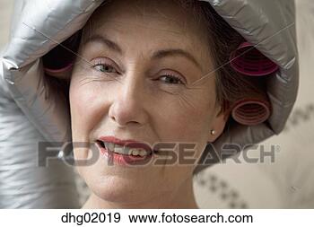 Stock Photograph - senior woman sitting 
under hair dryer. 
fotosearch - search 
stock photos, 
pictures, images, 
and photo clipart