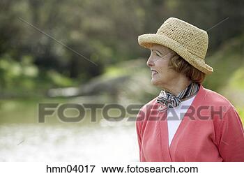 Picture - senior woman wearing 
straw hat. fotosearch 
- search stock 
photos, pictures, 
images, and photo 
clipart