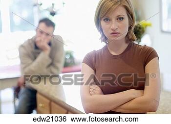 Stock Photo - serious woman 
posing for camera 
ignoring boyfriend. 
fotosearch - search 
stock photos, 
pictures, images, 
and photo clipart