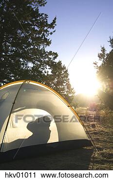 Stock Photography - silhouette of 
person waking 
up in tent. fotosearch 
- search stock 
photos, pictures, 
images, and photo 
clipart