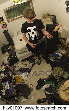 Picture - teenage boy playing 
electric guitar 
in messy room. 
fotosearch - search 
stock photos, 
pictures, images, 
and photo clipart