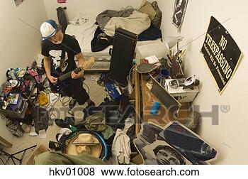 Stock Photo - teenage boy playing 
electric guitar 
in messy room. 
fotosearch - search 
stock photos, 
pictures, images, 
and photo clipart