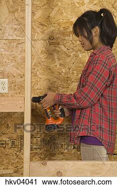 Stock Photography - teenage girl using 
drill. fotosearch 
- search stock 
photos, pictures, 
images, and photo 
clipart