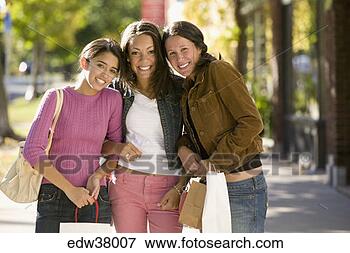 Picture - teenage girls 
walking with shopping 
bags. fotosearch 
- search stock 
photos, pictures, 
images, and photo 
clipart