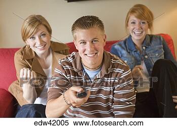 Stock Image - teenagers watching 
television. fotosearch 
- search stock 
photos, pictures, 
images, and photo 
clipart