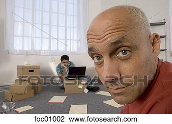 Stock Photo - two men working 
on moving boxes 
in office. fotosearch 
- search stock 
photos, pictures, 
images, and photo 
clipart