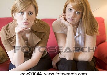 Stock Photo - two young women 
leaning their 
heads on their 
hands. fotosearch 
- search stock 
photos, pictures, 
images, and photo 
clipart