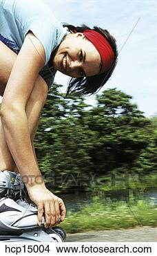 Stock Photo - woman adjusting 
rollerblades. 
fotosearch - search 
stock photos, 
pictures, images, 
and photo clipart