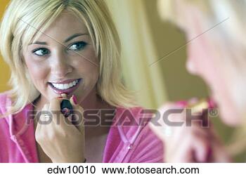 Stock Photography - woman applying 
lipstick. fotosearch 
- search stock 
photos, pictures, 
images, and photo 
clipart