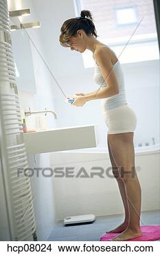 Stock Photo - woman brushing 
her teeth. fotosearch 
- search stock 
photos, pictures, 
images, and photo 
clipart