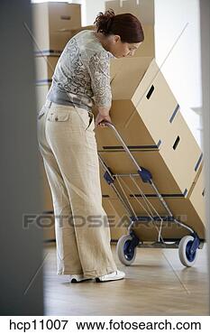 Picture - woman hauling 
stacked boxes. 
fotosearch - search 
stock photos, 
pictures, images, 
and photo clipart