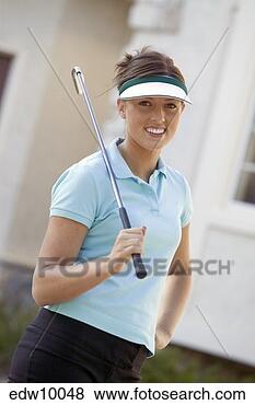 Stock Photo - woman holding 
golf putter. fotosearch 
- search stock 
photos, pictures, 
images, and photo 
clipart