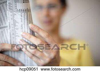 Stock Photography - woman reading 
stocks in newspaper. 
fotosearch - search 
stock photos, 
pictures, images, 
and photo clipart