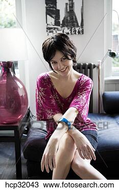 Stock Photo - woman smiling 
in livingroom. 
fotosearch - search 
stock photos, 
pictures, images, 
and photo clipart