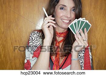 Stock Photo - woman smoking 
and holding playing 
cards. fotosearch 
- search stock 
photos, pictures, 
images, and photo 
clipart