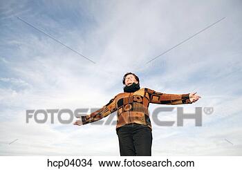 Stock Photo - woman standing 
with outstretched 
arms. fotosearch 
- search stock 
photos, pictures, 
images, and photo 
clipart