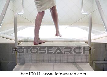 Stock Photography - woman stepping 
into hot tub. 
fotosearch - search 
stock photos, 
pictures, images, 
and photo clipart