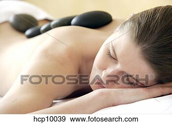 Stock Photograph - woman with therapeutic 
hot stones on 
back. fotosearch 
- search stock 
photos, pictures, 
images, and photo 
clipart