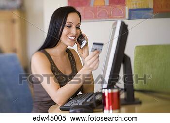Stock Image - woman using credit 
card to shop over 
telephone. fotosearch 
- search stock 
photos, pictures, 
images, and photo 
clipart
