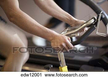 Stock Photography - woman using stationery 
bicycle. fotosearch 
- search stock 
photos, pictures, 
images, and photo 
clipart